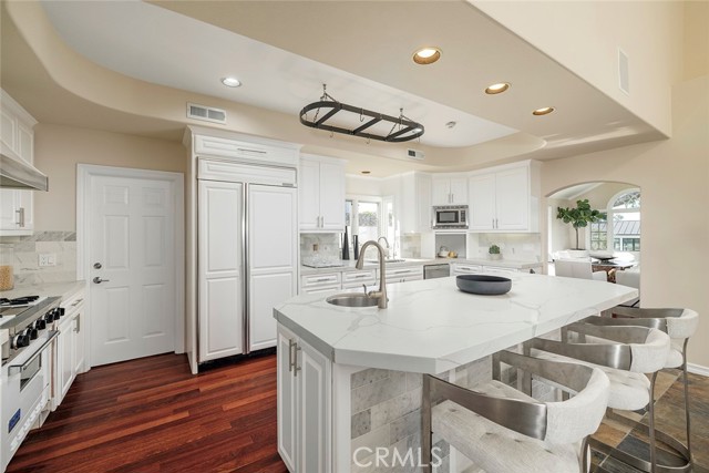 Kitchen flows well between formal and informal dining areas.