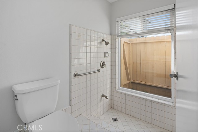 Primary en-suite bathroom has a sunken shower with tile floors!