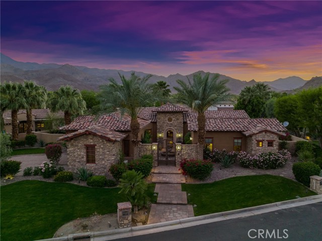58473 Quarry Ranch Road La Quinta, California This is a fabulous opportunity to purchase a celebrated Quarry home with endless, seldom found privacy and tranquility! Pass through the iron gates to a manicured courtyard with a lovely fountain, through the front door, where once inside the floor to ceiling stone foyer, you will immediately become aware of the graceful sophistication the home holds. Owners and their exclusive guests will discover many indoor and outdoor living spaces to enjoy. The culinary kitchen offers a large Quartzite island and Marble backsplash - prep sink, walk-in pantry, and BRAND NEW Stainless Viking professional appliances, with a wall of windows allowing for a paramount view of the private pond and waterfall. Follow the seamless flow to the living area where you will find soaring ceilings with upgrades that include: Rugged post and beam ceilings with an awe-inspiring stacked stone custom fireplace. The fireplace anchors the open living area with wood/glass pocket doors leading to an outdoor dining area with a double-sided fireplace and a view of the private pond. The owners suite offers recent upgrades of walls of stone, romantic fireplace, and soaring rugged post and beam ceilings. Slide the pocketed doors to view a custom saltwater pool, spa, and water features. The owners suite has a soaking tub, walk-in shower, 2 walk-in closets, and 2 water closets for his/hers. Enjoy a movie or watch your next golf game in the adjacent Office/theater room. This spectacular home is 4160 +/- 4 full bedrooms bd/ensuite bath plus powder room. This includes 1 owners suite, 1 room with a private outdoor entry for guests, 1 home office/theater room, 1 separate casita with a private outdoor entry for guests, and 4 fireplaces. If you are seeking privacy, this home has it! Located on a secluded pond with running stream, over 1/3 acre of lush brand new landscaping, private, gated courtyard entryway, deep driveway with 3 door garage, not easily visible from the roadway. Hurry while golf club memberships are still available at this top 100 ranked course, where championship golf meets unparalleled beauty. The Quarry's 18-hole Championship Course, 10-hole Short Course, and 18-hole Putting Course are all designed by world-renowned golf course architect, Tom Fazio. Membership is by invitation only and is strictly limited to 250 members to ensure that the first tee is always open and available for its members (They are currently close to capacity).