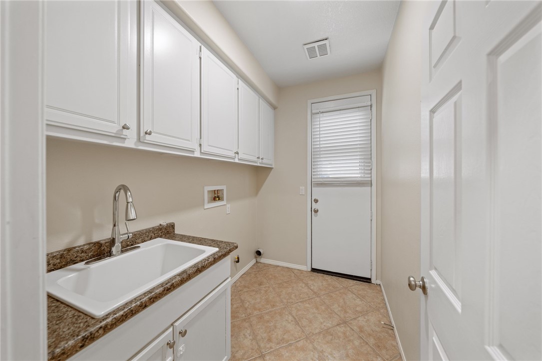 Laundry room with door to sideyard