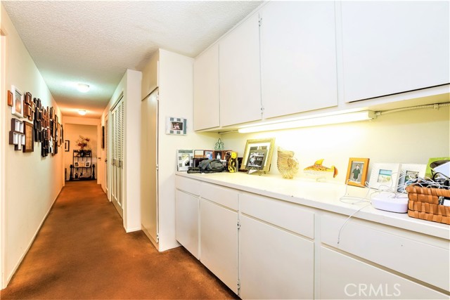 This a View of the Hallway from the opposite end near the Master Bedroom Suite. There is a Large Storage Credenza, The Laundry Closet and three other Storage Areas. Opposite the Cradenza is a Second Bedroom and Full Bath.