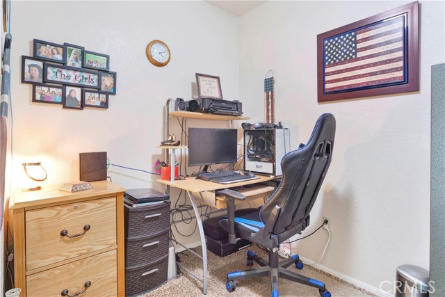 Office room located just off the living room is perfect for hobby space or home office.