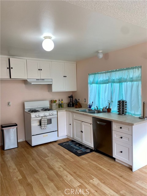 Kitchen with newer floors and counter tops. Open and bright!