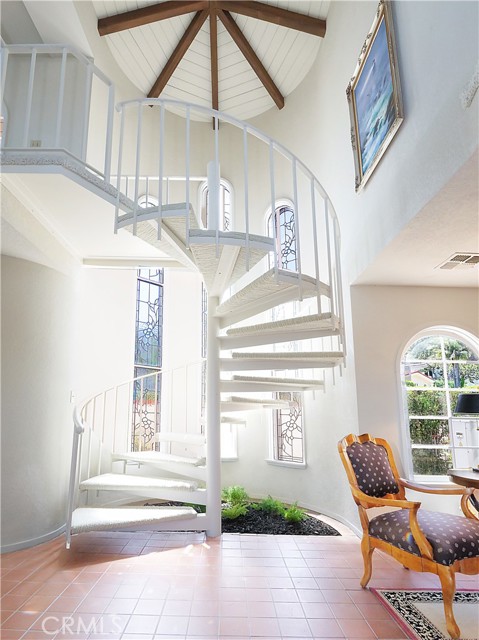 Spiral stairway to 2nd Floor family room adjacent to Master Bedroom in addition to main stairway