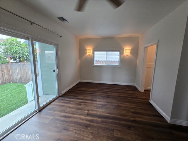 Primary bedroom with access to the private backyard.