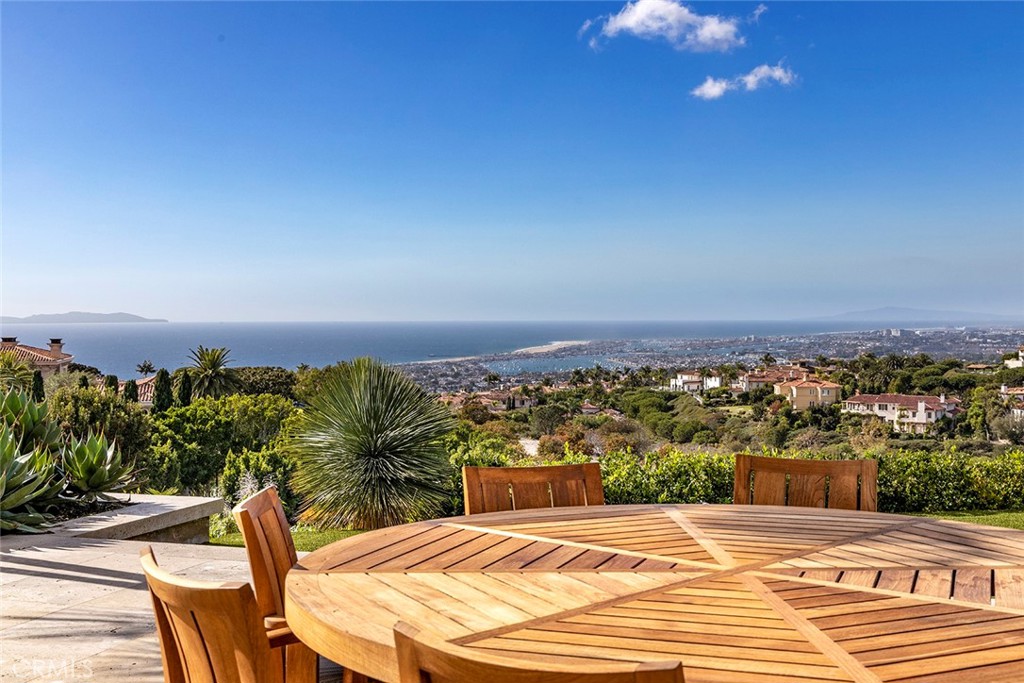 Experience luxury living at its finest with this breathtaking panoramic oceanview estate in the exclusive Pelican Crest community of Newport Coast. With awe-inspiring views of the Pacific Ocean, white-water coastline, and twinkling lights of Newport Harbor, this property is the epitome of sophistication and comfort meticulously constructed by renowned builder, Mark Falcone. Boasting a spacious 11041 Sq ft sq. ft. home on a 16,525 sq. ft. lot, this 6-bedroom, 10-bathroom property is designed with a calming transitional style and finished to the highest standards of quality and craftsmanship. From the expansive foyer to the wood-clad office and artfully designed Bulthaup kitchen, every detail has been carefully considered to create a welcoming and relaxing atmosphere. Take in the stunning views from the light-filled common living areas, which flow seamlessly into the resort-style exterior grounds. Enjoy a dip in the pool, soak in the spa, or dine al fresco under the covered loggias. The tranquil water features, lounge areas, and dining spaces are perfect for entertaining or simply enjoying the peace and serenity of your surroundings. Other amenities of this luxurious property include a home gym, wine cellar and tasting room with windows showcasing the depths of the pool, cinematic theater, billiards room, bar, home spa, laundry, and commercial elevator to all three levels. The massive subterranean garage offers ample space for your vehicles and storage needs. This exquisite estate is truly one-of-a-kind and must be seen to be fully appreciated. Don't miss this opportunity to own a piece of paradise in the highly sought-after Pelican Crest community.
