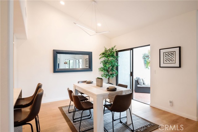 Dining area with modern light fixture leading into the back patio