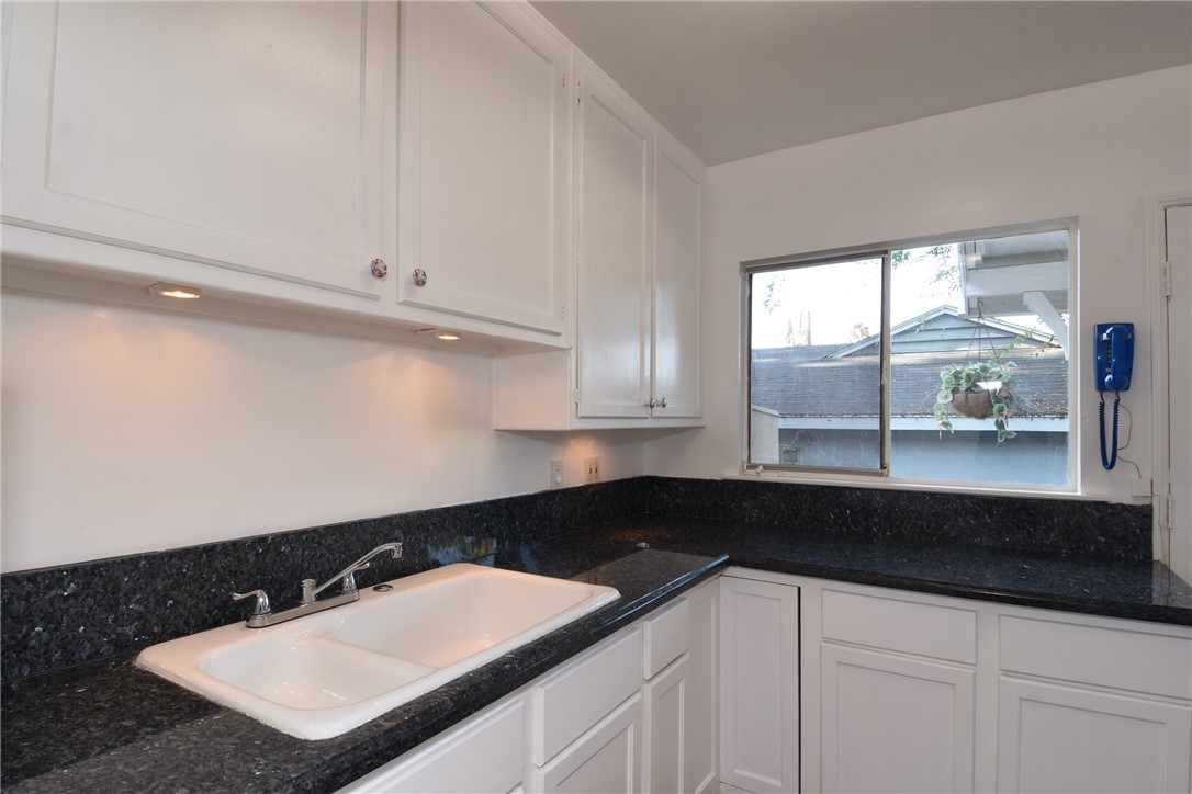 Close up view of the beautiful granite counter tops, and the double sink.