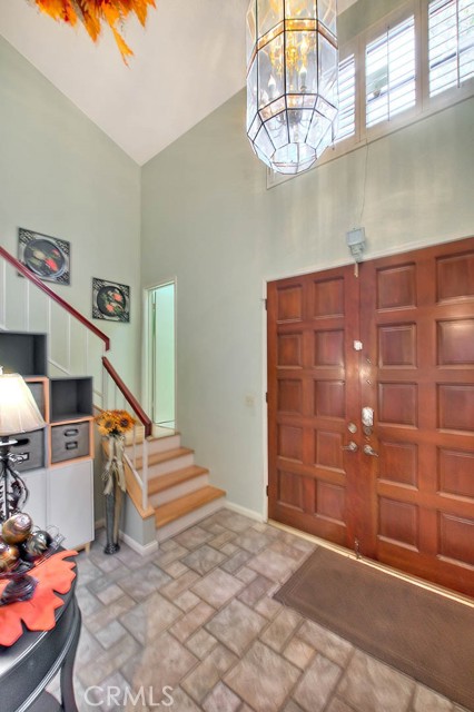 Formal Foyer Entry Way With Spacious Open Ceiling & Chandelier.  Excellent Feng Shui.  Easy Care Ceramic Tile Flooring