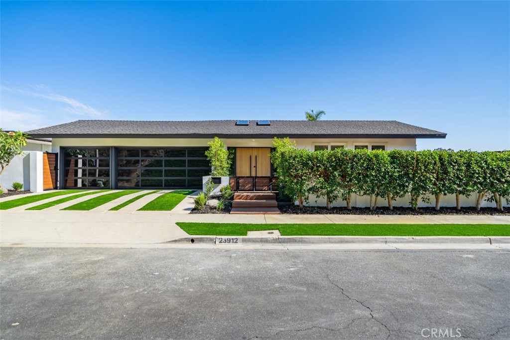 Nestled in the prestigious Salt Creek neighborhood of Laguna Niguel, this stunning remodeled home offers a perfect blend of luxury and comfort. With 4 bedrooms, 3 bathrooms, and 2,338 square feet of meticulously designed living space, this property is ideal for those seeking a serene and upscale lifestyle.
Situated on a generous 12,632 square foot lot, the home provides ample outdoor space, featuring a beautifully landscaped yard with custom Mangaris wood decks in both the front and backyard, artificial turf, and a custom cable railing. The spacious 3-car garage and single loaded street enhance privacy and convenience.
This home is situated in the sought-after Vista Del Niguel subdivision, offering a peaceful and serene atmosphere with breathtaking golf course views. 
Step inside to discover a modern oasis. The new panel-ready kitchen appliances from Signature Kitchen, complemented by Bedrosians Porcelain Slab in Calacatta Super White, set the tone for culinary excellence. The kitchen also boasts a sleek black granite sink, mouth-blown glass pendants from Arhaus, and a geometric dining pendant from CB2, creating an inviting space for entertaining and daily living.
The home is adorned with new interior glass panel shaker doors, black panel mirrored closet doors in all bedrooms, and stylish Top Knob matte black cabinet pull handles. The fully remodeled primary bath features a custom rift white oak vanity, a fluted standalone tub, and Delta champagne bronze finishes. Each bathroom is equipped with new Toto toilets, ensuring a luxurious and comfortable experience.
Additional highlights include brand new courtyard French doors with SmartKey locks from Urban Doors, modern front entry doors in white oak with commercial-grade stainless steel pull handles, and new exterior light fixtures. The aluminum frame garage door, new smooth stucco, recessed lighting throughout, and paid solar panels enhance the home’s modern aesthetic and energy efficiency.
For outdoor enthusiasts, the property features a custom outdoor kitchen and BBQ area, a Spa Hot Tub by Aqua Rest with 30 jets, a custom pergola with string lights, and meticulously designed landscaping with concrete pavers, gravel, mulch, and 15-gallon ficus and Podocarpus plants. The new TPO roof and rain gutters ensure durability and low maintenance.
Experience the epitome of luxury living in Laguna Niguel with this remarkable property.