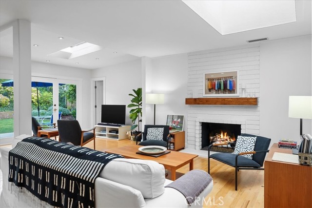 Formal living room with tons of natural light and a gas fireplace.