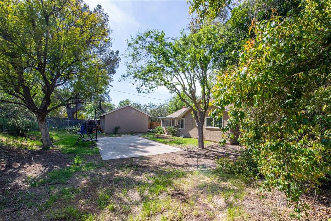 The trees provide plenty of shade in the backyard.