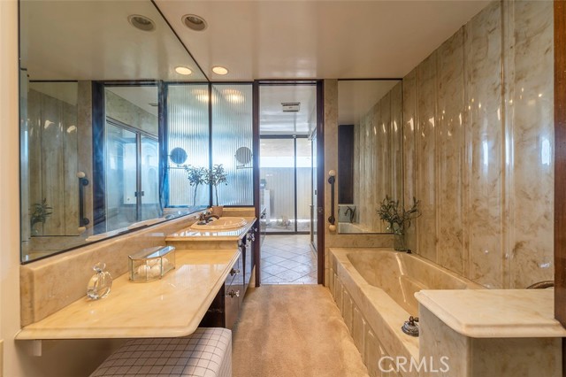 Primary Bathroom  with Soaking Tub and  Access to Backyard and Pool