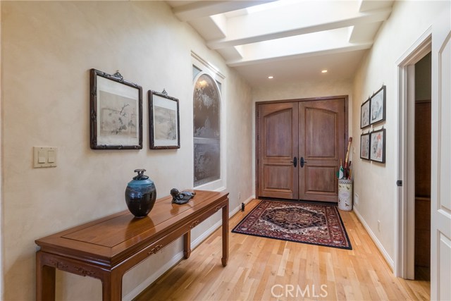 The stately and inviting entry way is bathed in natural sunlight.