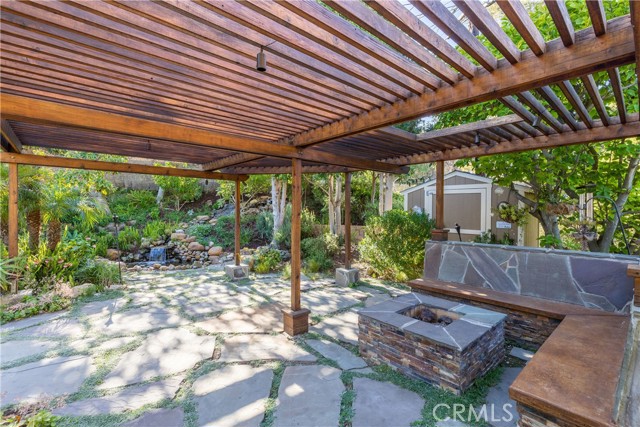 Be ready for the warm days and cool nights of the Palos Verdes Peninsula in an ambiance of paradise under the pergola covered conversation seating around the natural-gas fire pit.