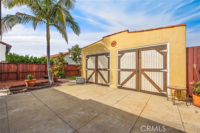 2 Car oversized garage with front driveway access and rear alley access.  portions of the garage converted to studio with sound proofing materials and an office