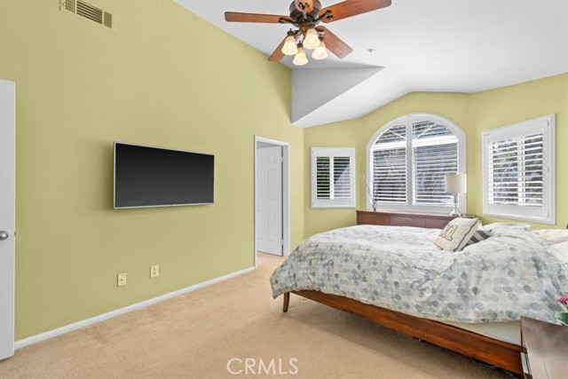 Primary bedroom with Vaulted Ceiling and ceiling fans