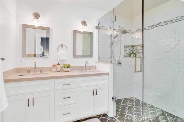 Double Sink Quartz Counter and walk in shower ensuite connected to Primary Bedroom