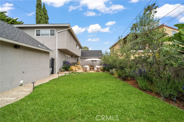 Lush grassy area.  View from virtually staged relaxing area.