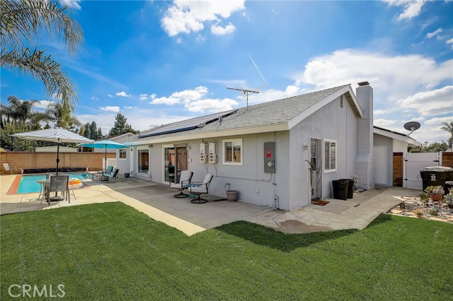 Rear yard with grass area and swimming pool.