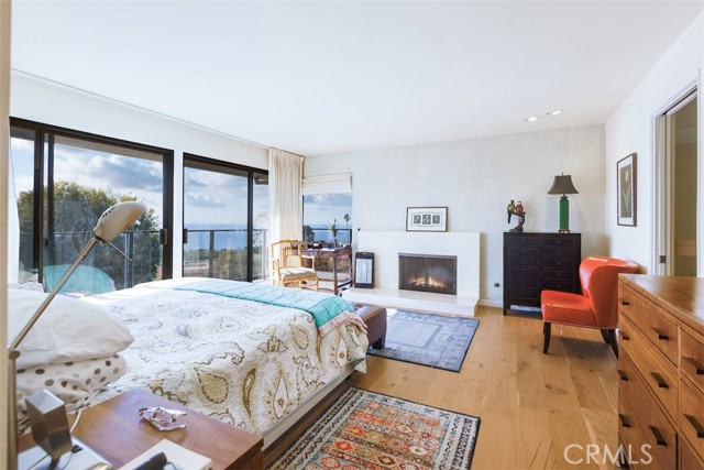 Master bedroom features a fireplace and sweeping view