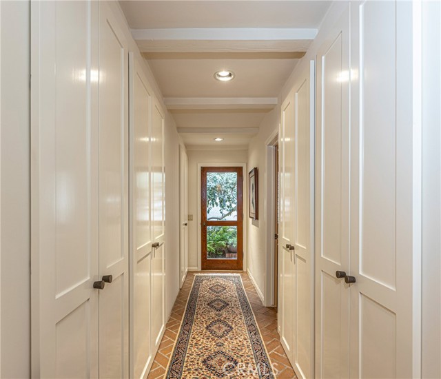 So much storage has been carefully worked into a lovely hallway and door that leads to the Guest House and Backyard.