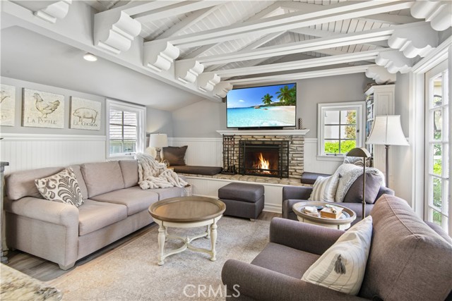 Family room with wood beamed ceiling and fireplace