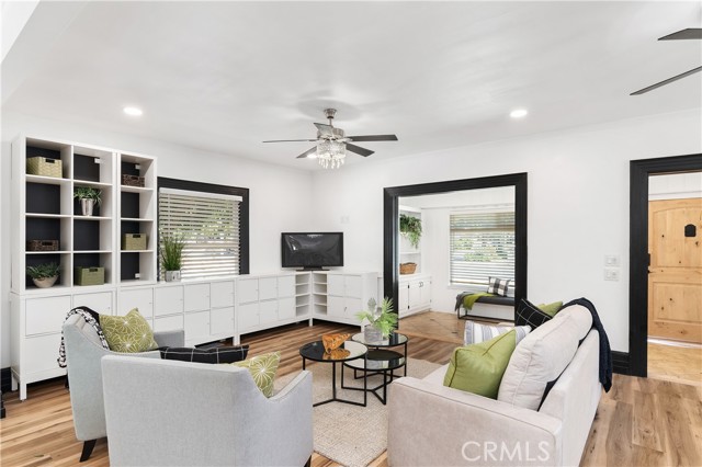 Storage cabinets and bins line the living room walls.