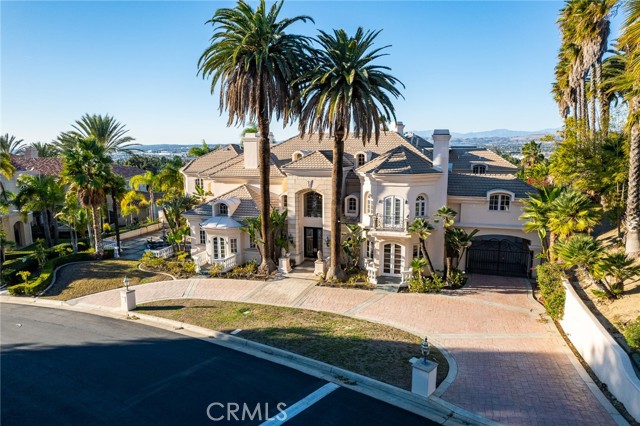 Spectacular Custom estate located in one of North Orange County’s most 24 hour prestigious guard gated communities. Own your Dream Home of Panoramic City light View and Private tennis Court.  There is no comparison to any other homes. 6 Bedrooms Plus Library with all Individual Bathrooms. Lavish Master bedroom with Large Walkin closet and Sauna Room.  Entertainment Movie Center. Gym Room, lot of Amenities...Surrounded by lush landscaping and soaring palm trees, the expansive grounds offer limitless possibilities for your own dramatic pool, entertainers Patio, sport court, etc. Full size of private tennis court and lightings. Huge garage can park 5-6 cars. You will not want to miss this rare opportunity to come home to this truly remarkable Copa De Oro estate!