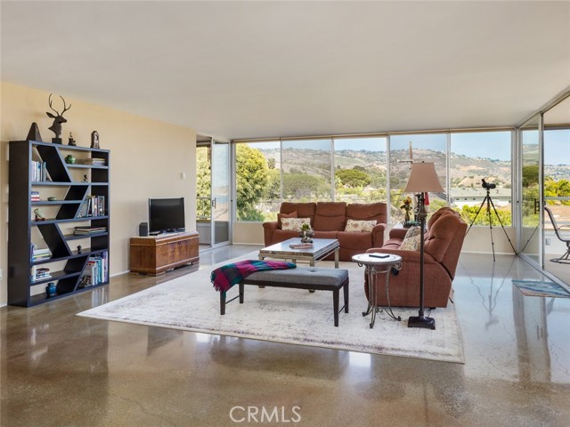 Beautiful, well-lit living room with huge windows for views. You can access both balconies from the living room. Floors are polished concrete.