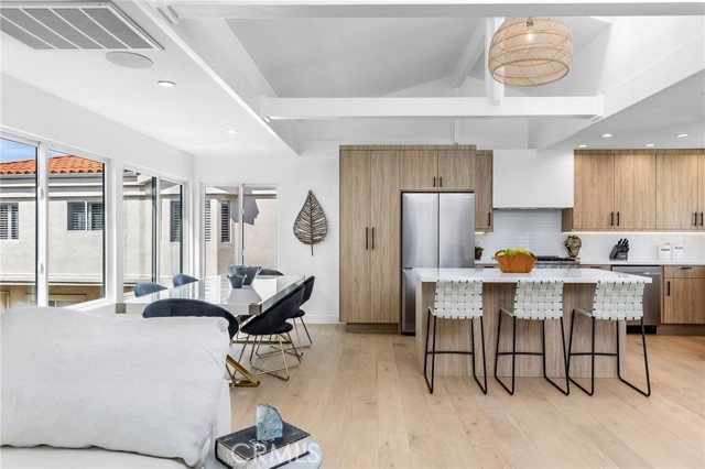 The kitchen island has a Microwave, refrigerated wine cooler and storage space.