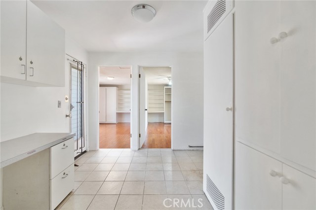 Laundry area with plenty of storage and a built in desk.