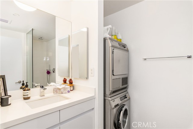 Stacked Miele washer/dryer in the full bathroom