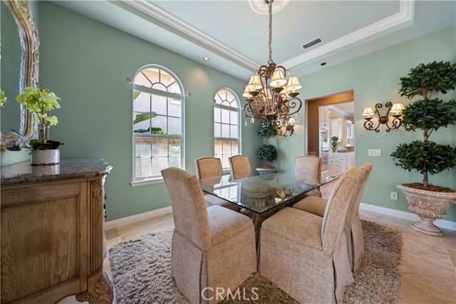 Formal dining room with custom chandelier, arch windows and decorator paint.