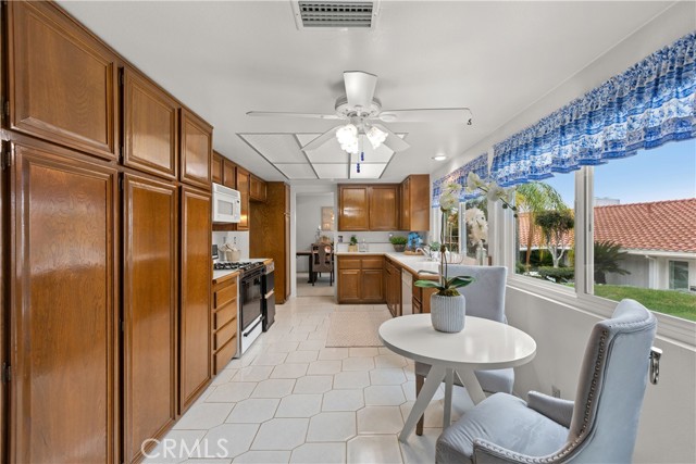 Large kitchen with DBL Pane windows, ceiling fan, and beautiful Oak cabinets.