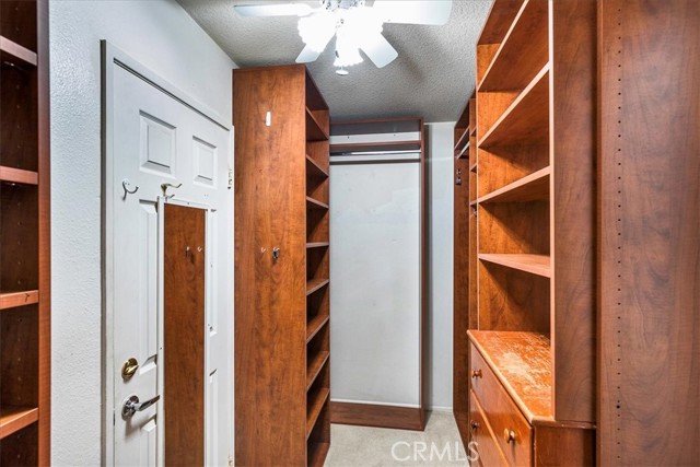 Primary closet with lots of storage.