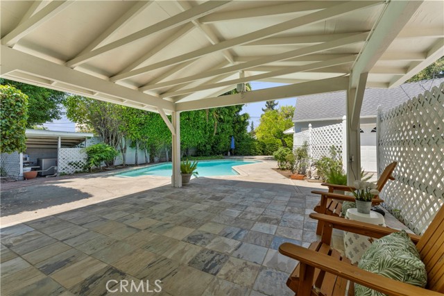 Covered patio and pool. Pool equipment to the left of image.