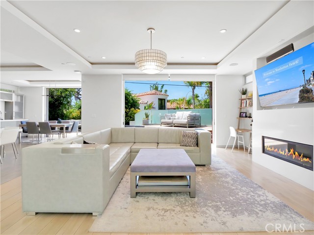 Living room with fireplace overlooking the large backyard.