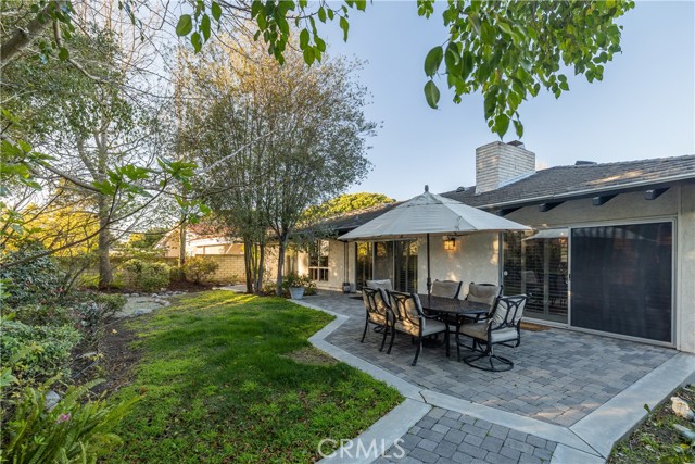 The backyard and garden is beautifully landscaped with decorative stone pavers.