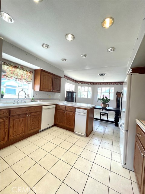 The kitchen cabinets, although a darker wood, are still in excellent condition, and perhaps with a bleach treatment brought further into the beach genre.