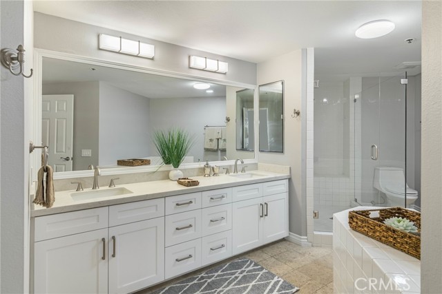 Amazing primary bathroom is huge for a 2 bedroom condo.  Enjoy frameless shower, dual vanities, new lighting, soaking tub and more