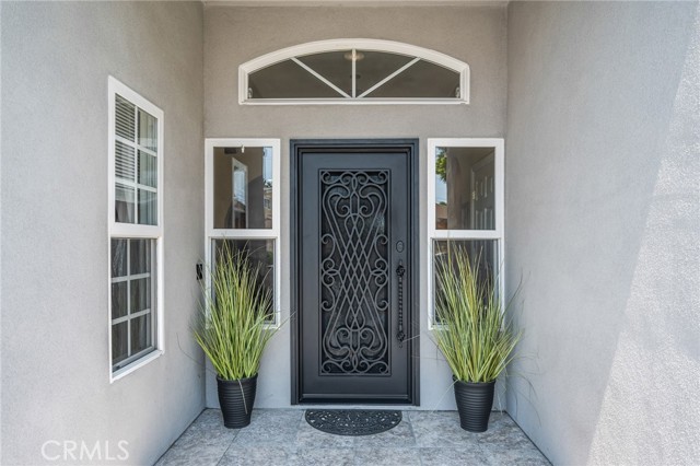 Quintessential custom iron entry door with a glass panel opening