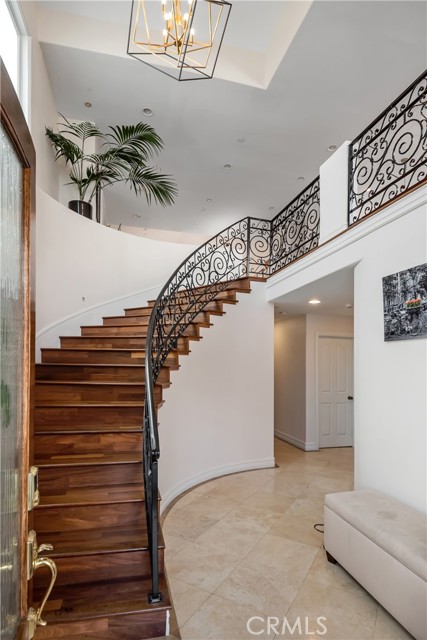 Gorgeous sweeping staircase leads you upstairs