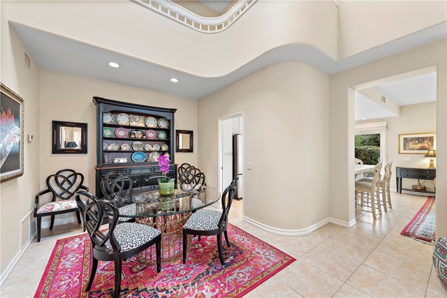 Formal dining room. Note the sweeping staircase