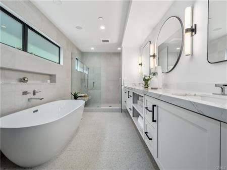 Primary bathroom. Soaking tub, custom cabinetry and large walk in shower