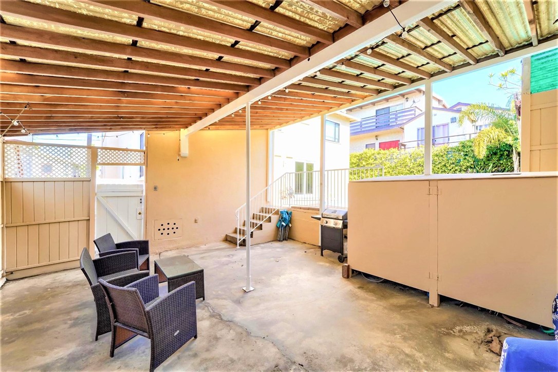 The covered deck has a storage area and a cabinet with the pool equipment.