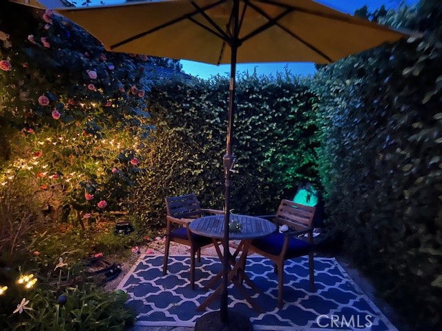 Seating in garden area of front yard, behind a wall of topiaries