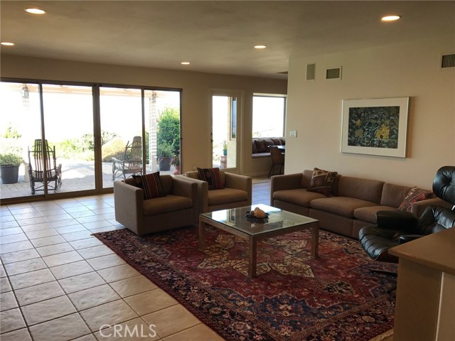 Another view of the family room with panoramic views and beautiful natural light, adjacent to the kitchen and the formal dining room.