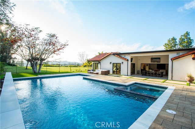 26392 Colina Drive Mission Viejo, California This fully furnished, UTILITIES INCLUDED 4 bedroom 4.5 bath resort-like, single-level stunner was completely rebuilt just over a year ago. The perfect union of Santa Barbara style and Modern Farmhouse Chic, it's designed to entertain, highlighting an awesome location. Resort like backyard with Oversized pool and spa showcases dramatic lighting and water features. There are multiple outdoor living spaces, spotlighted by covered dining in the California room with dual flat screen TVs, a deep-seating patio set surrounding a sleek fire pit and fantastic sunset views. Automated outdoor Audio System and La Cantina folding wall with French Doors offer seamless indoor-outdoor entertaining flow, and still room left for a Kids Playhouse/Swing Set. The European Oak wood flooring (featured throughout the house) imbues historic charm as you enter the living room flanked by the custom floor-to-ceiling built-in bookcase, with piano nook, accentuated by a rustic Restoration Hardware candelabra chandelier.
Gorgeous, bright kitchen, overlooking private park, highlighted by high-end marble counters, top-of-the line appliances, and custom statement-making hood. Dining room cozy enough to seat 8, but large enough for 12 or more, with dramatic sunset views and one-of-a-kind light fixture. Larger secondary bedrooms, statement bathrooms, and a stunning master suite make this a "must see". Centrally located to SoCal attractions: 20+ minutes to Disneyland, beaches, and Legoland.