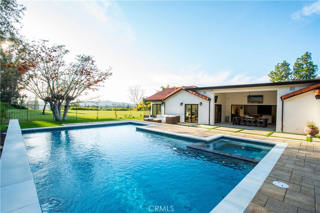 This fully furnished, UTILITIES INCLUDED 4 bedroom 4.5 bath resort-like, single-level stunner was completely rebuilt just over a year ago. The perfect union of Santa Barbara style and Modern Farmhouse Chic, it's designed to entertain, highlighting an awesome location. Resort like backyard with Oversized pool and spa showcases dramatic lighting and water features. There are multiple outdoor living spaces, spotlighted by covered dining in the California room with dual flat screen TVs, a deep-seating patio set surrounding a sleek fire pit and fantastic sunset views. Automated outdoor Audio System and La Cantina folding wall with French Doors offer seamless indoor-outdoor entertaining flow, and still room left for a Kids Playhouse/Swing Set. The European Oak wood flooring (featured throughout the house) imbues historic charm as you enter the living room flanked by the custom floor-to-ceiling built-in bookcase, with piano nook, accentuated by a rustic Restoration Hardware candelabra chandelier. 
Gorgeous, bright kitchen, overlooking private park, highlighted by high-end marble counters, top-of-the line appliances, and custom statement-making hood. Dining room cozy enough to seat 8, but large enough for 12 or more, with dramatic sunset views and one-of-a-kind light fixture. Larger secondary bedrooms, statement bathrooms, and a stunning master suite make this a "must see". Centrally located to SoCal attractions: 20+ minutes to Disneyland, beaches, and Legoland.